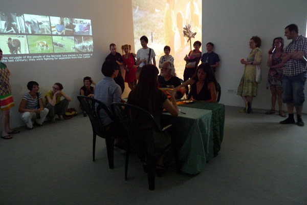 Lia Lapithi, The Grass is Greener on the Other Side. Multi channel video installation, interactive food art performance, fondue, 2-tone tablecloth, 2012